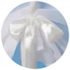 A close-up of a white satin bow tied on a white fabric. Voir les images du produit