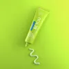 A tube of Curaprox toothpaste is shown on a gradient green background, with a swirl of toothpaste on the surface below. Anteprima dell’immagine prodotto