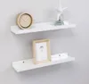 Two white shelves mounted on a light gray wall, decorated with a clock, a starfish decoration, and a picture frame. Anteprima dell’immagine prodotto