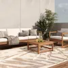 An outdoor living space with a sofa, armchair, coffee table, and rug. Náhled obrázku produktu