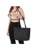 A woman is modeling a black shopper bag. Podgląd zdjęcia produktu
