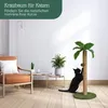 A black cat is playing with a cat tree that resembles a palm tree in a living room setting. Podgląd zdjęcia produktu