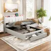 A bedroom scene featuring a white upholstered bed with storage, a rug, and a bedside table. Produktbild-Vorschau