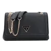 A black Guess handbag with a gold chain strap is shown against a white background. Produktbild-Vorschau