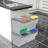 A kitchen setting with a sink and cabinets, featuring a stack of four BAMA Papierkorb POKER bins. Náhľad obrázku produktu