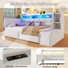 A white daybed with integrated storage and LED lighting, shown in a bedroom setting with decorative pillows and a throw blanket. Insets highlight the USB/Type-C charging port and the button-tufted headboard. Produktbild-Vorschau