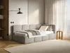 A modern bedroom with a grey upholstered bed and a wooden side table. Produktbild-Vorschau