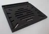 A black cast iron grate with a slatted opening is shown from a diagonal angle against a white background. Náhľad obrázku produktu