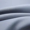 A close-up view of draped gray fabric, showing its texture and folds. Náhled obrázku produktu