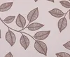 A close-up view of a fabric pattern with brown leaf motifs on a beige background. Produktbild-Vorschau
