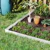 A garden bed with metal edging, plants, and a watering can. Produktbild-Vorschau