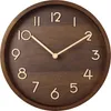 A close-up studio shot of a wooden wall clock. Voir les images du produit