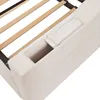 Close-up view of the upholstered frame of a bed, showing wooden slats and a small storage compartment. Náhľad obrázku produktu