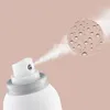 A close-up of a spray can nozzle emitting a mist, with a magnified circular inset showing water droplets. Náhled obrázku produktu