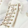 Close-up of a white sneaker boot with beige laces and a gold zipper. Produktbild-Vorschau