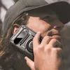 A person wearing a cap is holding a smartphone with a protective case to their ear. Náhľad obrázku produktu