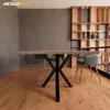 A dining room scene with a table and chairs, featuring a modern shelving unit in the background. Voir les images du produit