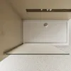A top-down view of a modern shower tray and glass shower screen. Produktbild-Vorschau
