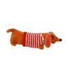 A plush toy dachshund wearing a striped sweater, isolated on a white background. Produktbild-Vorschau
