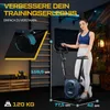 A woman is posing next to a stationary exercise bike in a home gym setting. The image includes text overlays highlighting product features and dimensions. Produktbild-Vorschau