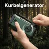 Hands holding a green crank-powered radio in a forest setting. Produktbild-Vorschau