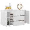 A white sideboard with three drawers and a cabinet on the left, decorated with a gold circular sculpture and some bottles and glasses on top. Produktbild-Vorschau