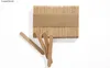 A bundle of wooden popsicle sticks is shown on a white background, with a few sticks scattered in front. Produktbild-Vorschau