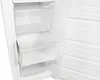 Interior view of an empty white freezer, showing clear drawers and shelves on the left and the freezer door interior with multiple compartments on the right. Produktbild-Vorschau