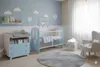 A nursery room with a crib, changing table, and armchair. Produktbild-Vorschau