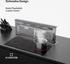 A kitchen scene showing a built-in cooktop with a pot of boiling water and a pop-up range hood. Produktbild-Vorschau
