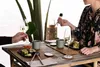 Two people are enjoying sushi and wine at a table. Produktbild-Vorschau