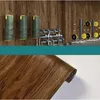 A collage showing a gym setup and a roll of wood-effect adhesive vinyl. Anteprima dell’immagine prodotto