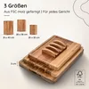 A stack of wooden cutting boards with a size indicator and FSC logo. Produktbild-Vorschau