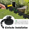 A hand is shown using a hammer to install black garden edging into the ground next to a lawn and plants. A coiled roll of the edging and a pile of stakes are also visible. Produktbild-Vorschau