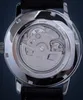 Close-up view of the back of a watch, showing the movement and inscriptions. Voir les images du produit
