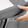 A close-up shot of a hand pressing a button on a gray baby crib. Anteprima dell’immagine prodotto