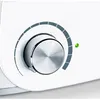 A close-up view of a white appliance with a silver dial and a green indicator light. Podgląd zdjęcia produktu