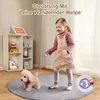 A young girl is playing with a toy robot dog in a room. Produktbild-Vorschau