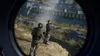 Two soldiers in tactical gear are looking out over a landscape with a large industrial structure in the background. Podgląd zdjęcia produktu