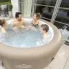 A family enjoying a hot tub on a patio. Produktbild-Vorschau