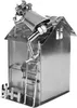 A metal figurine of a house with a figure on the roof working on the chimney. Náhľad obrázku produktu