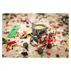A LEGO-compatible mug filled with a yellow liquid and a purple straw, surrounded by scattered LEGO bricks on a carpeted floor. Anteprima dell’immagine prodotto
