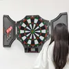 A woman is playing darts in front of a dartboard mounted on a white wall. Náhľad obrázku produktu