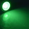 A green LED spotlight illuminates a dark surface, creating a bright green beam and reflection. Produktbild-Vorschau