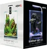 The image shows the packaging for two AQUAEL Shrimp Set 20 aquariums, one on a white background and the other on a black background, highlighting their 'Day & Night' feature. Voir les images du produit