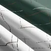 Close-up view of folded green and white fabric with a plaid pattern. Produktbild-Vorschau