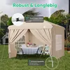 A beige pop-up canopy tent set up in a backyard with a table and chairs inside, under a stormy sky. Podgląd zdjęcia produktu
