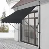 A black awning is extended over a wooden deck in front of a large window. Anteprima dell’immagine prodotto