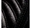 A close-up view of black leather with stitching. Anteprima dell’immagine prodotto