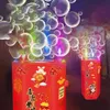 Rote Blasenmaschine, verziert mit chinesischen Neujahrsmotiven, die bunte Blasen und Licht in einer dunklen Umgebung ausstößt Voir les images du produit